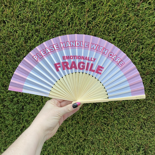 Handheld Fan with pink and white lettering reading "Please handle with care, Emotionally Fragile" with natural Bamboo Spines