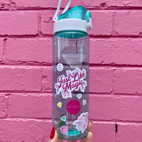 Two bold coloured fun sticker on a water bottle held up in front of a pink brick wall. Featuring stickers such as Eat the Rich, Just like Magic, You are Art.